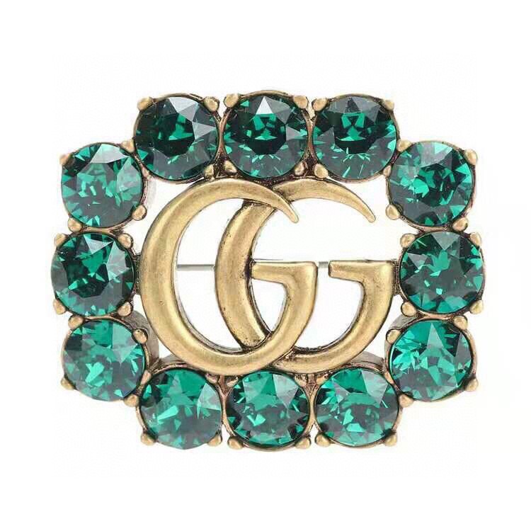 G*u*i brooches